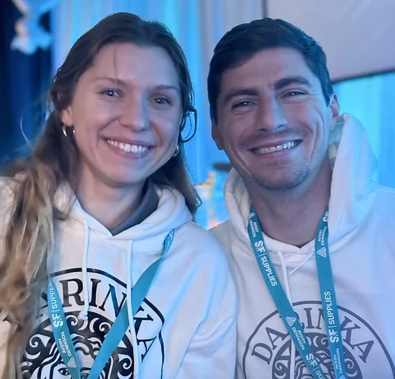 Dariia and Dmytro, owners of Darinka Signs, wearing Darinka Signs hoodies
